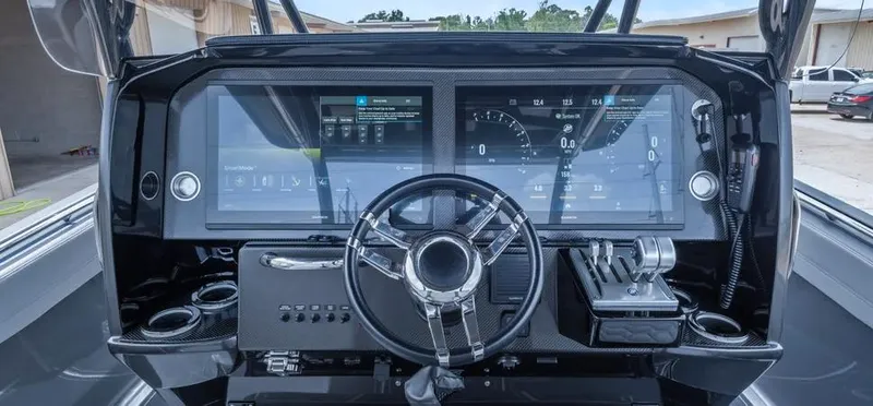 Slide: The Image of 2023 Nor-Tech 390 Sport Center Console dashboard with advanced controls and digital displays. - 6