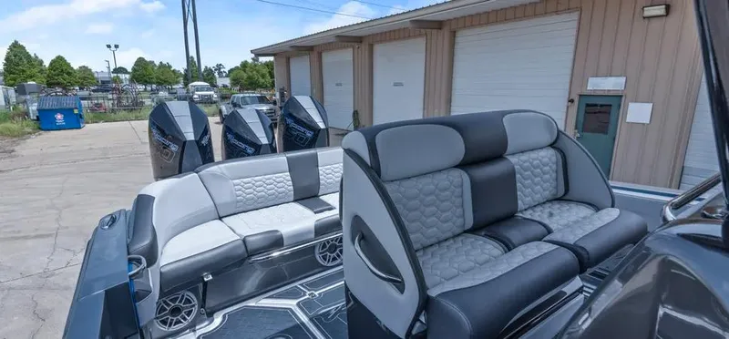 Slide: The Image of 2023 Nor-Tech 390 Sport Center Console boat with luxurious seating and powerful engines. - 9