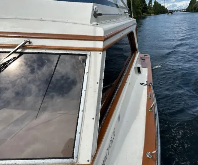 Slide: The Image of 1978 Egg Harbor 36 Sedan cruising on a calm lake, showcasing classic design and craftsmanship. - 14