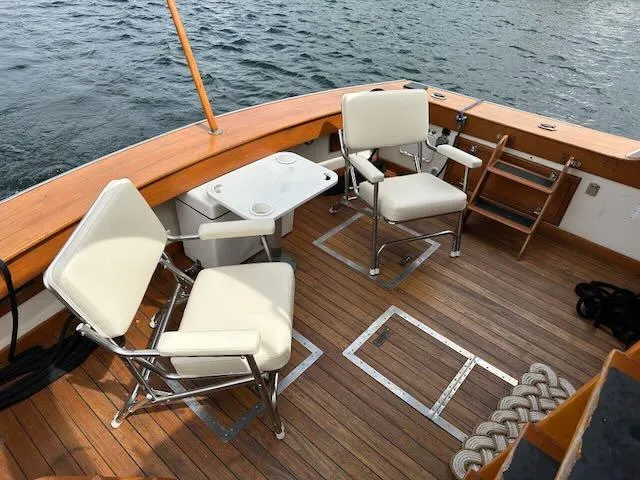 Slide: The Image of 1978 Egg Harbor 36 Sedan boat deck with chairs and table on wooden flooring. - 19