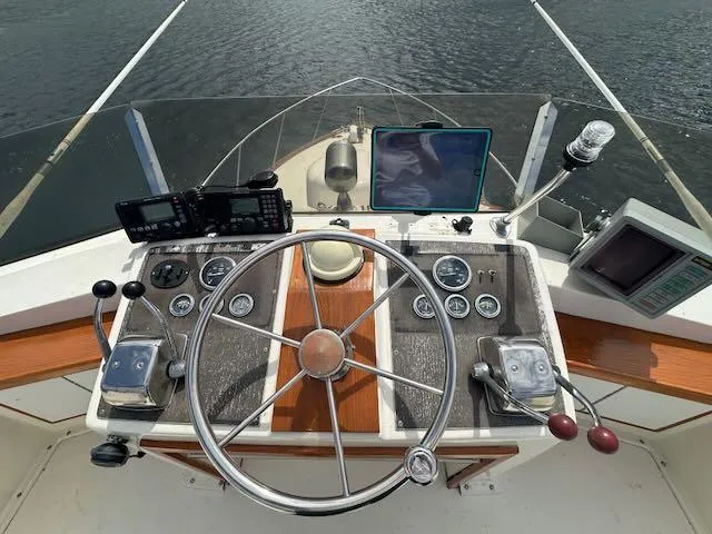 Slide: The Image of 1978 Egg Harbor 36 Sedan boat helm with steering wheel and navigation instruments. - 36