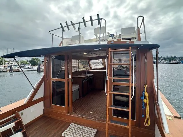 Slide: The Image of 1978 Egg Harbor 36 Sedan boat with open cabin, docked by the waterfront. - 42