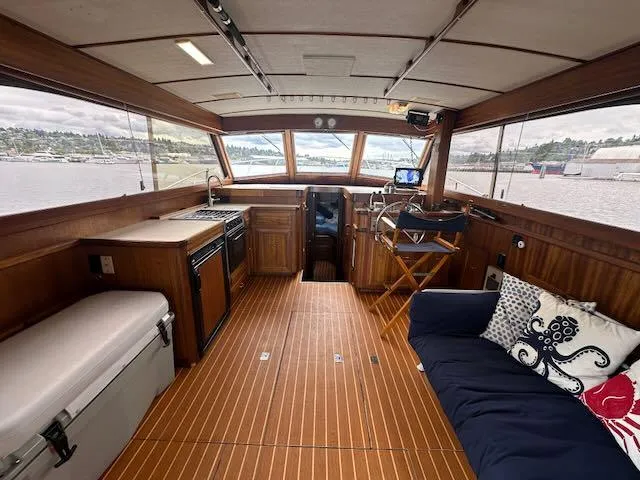 Slide: The Image of 1978 Egg Harbor 36 Sedan interior with wood finish, seating, and waterfront view. - 46