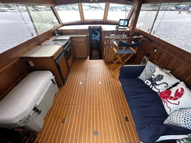 Slide: The Image of 1978 Egg Harbor 36 Sedan interior with wood flooring, kitchenette, and seating area. - 48