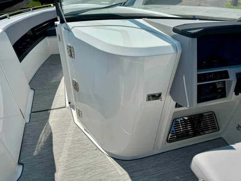 Slide: The Image of 2022 Cobalt A29 boat interior with sleek white cabinetry and modern dashboard. - 13