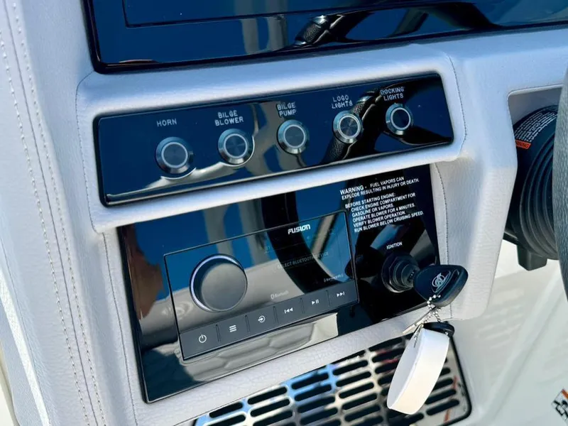 Slide: The Image of Control panel of a 2022 Cobalt A29 boat with various switches and a Fusion audio system. - 20