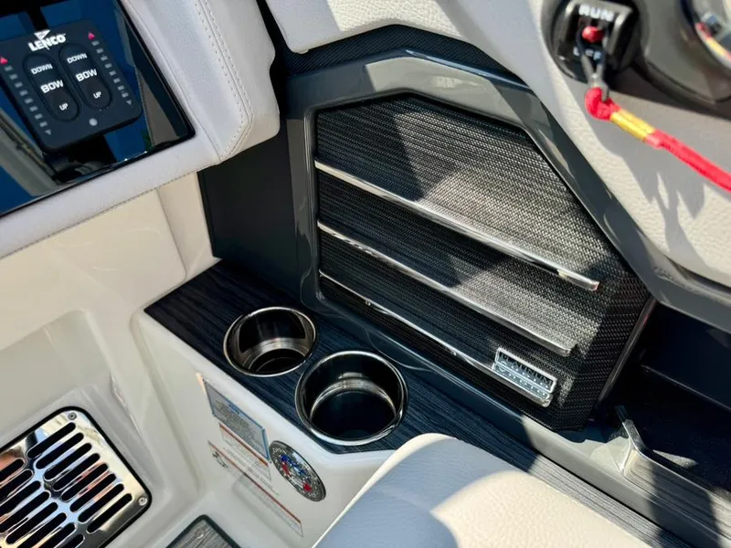 Slide: The Image of 2022 Cobalt A29 boat interior with cup holders and control panel. - 26