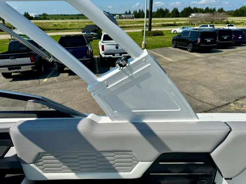 Slide: The Image of 2022 Cobalt A29 boat interior with sleek design and modern features, parked near vehicles. - 30