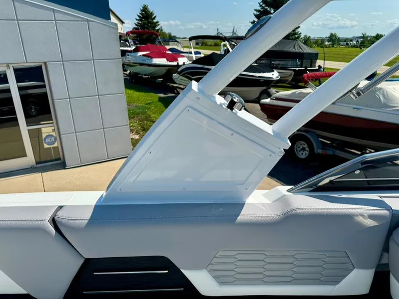 Slide: The Image of 2022 Cobalt A29 boat interior with sleek design, parked near other boats. - 31