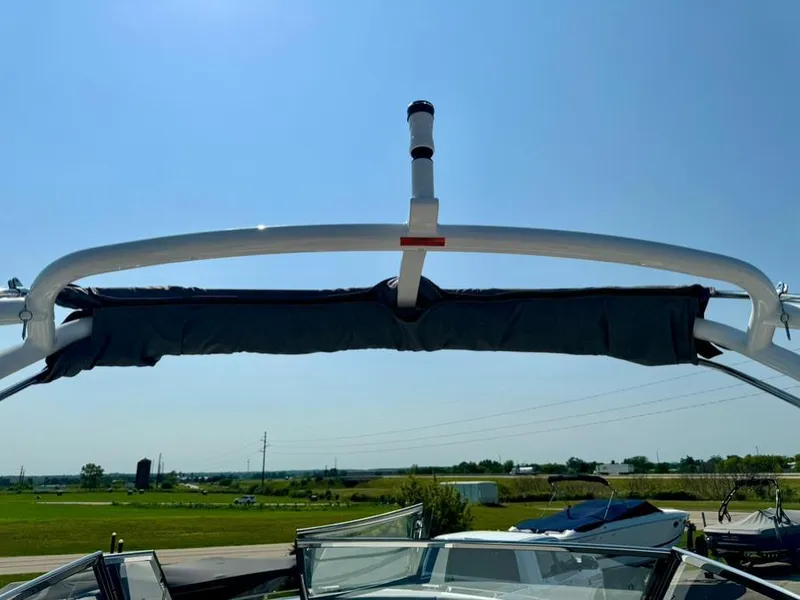 Slide: The Image of 2022 Cobalt A29 boat with a wakeboard tower against a clear blue sky. - 32
