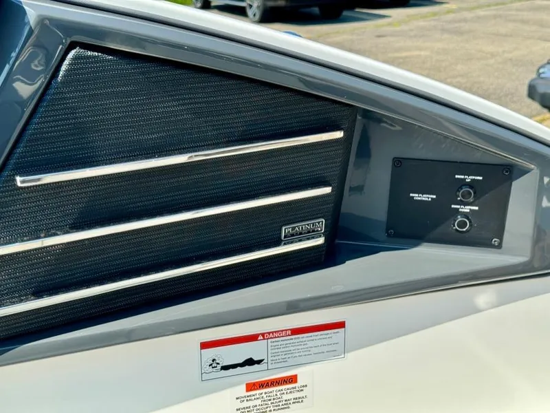 Slide: The Image of 2022 Cobalt A29 boat speaker panel with control knobs and warning labels. - 46