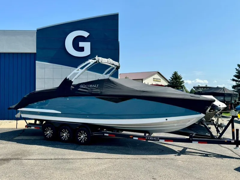 Slide: The Image of 2022 Cobalt A29 boat on trailer, covered, parked outside dealership. - 48