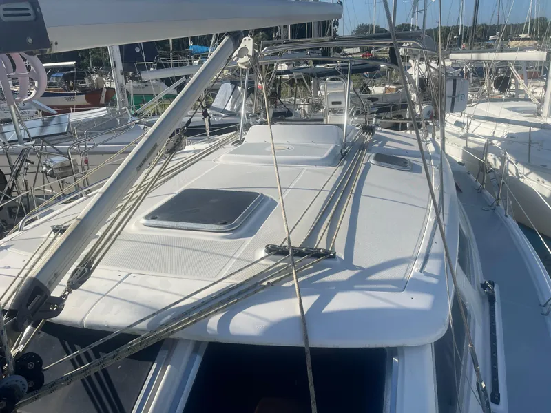 Slide: The Image of 2004 Hunter 44 DS Deck Salon sailboat with open cabin entrance, docked in marina. - 10