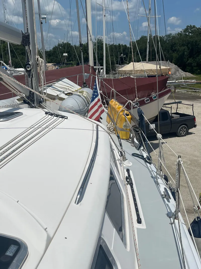 Slide: The Image of 2004 Hunter 44 DS Deck Salon sailboat deck with rigging and hatches. - 13