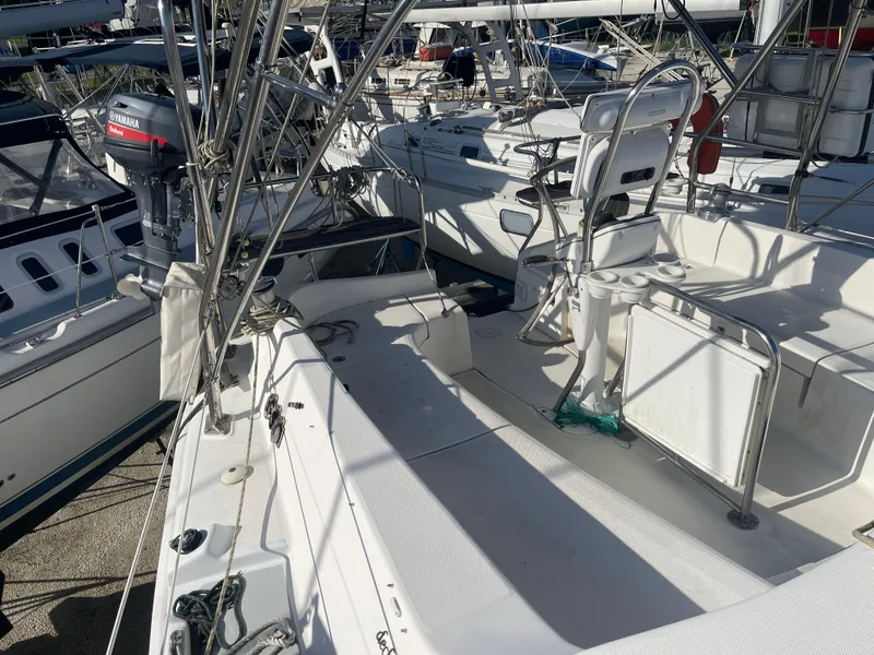 Slide: The Image of 2004 Hunter 44 DS Deck Salon sailboat with rigging and deck view in marina. - 14