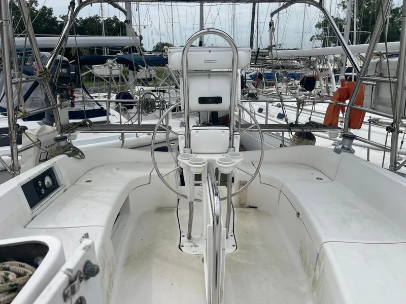 Slide: The Image of 2004 Hunter 44 DS Deck Salon sailboat on land, surrounded by other boats. - 19