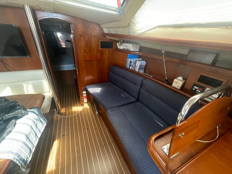 Slide: The Image of Hunter 44 DS Deck Salon 2004 sailboat docked among other boats in a marina. - 21