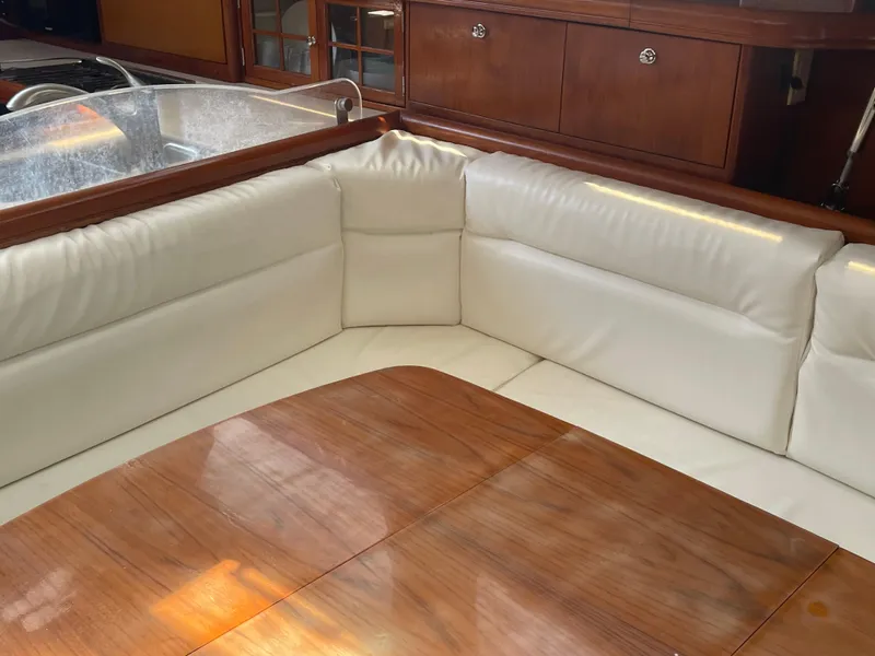 Slide: The Image of 2004 Hunter 44 DS Deck Salon sailboat in a marina, surrounded by other boats. - 22