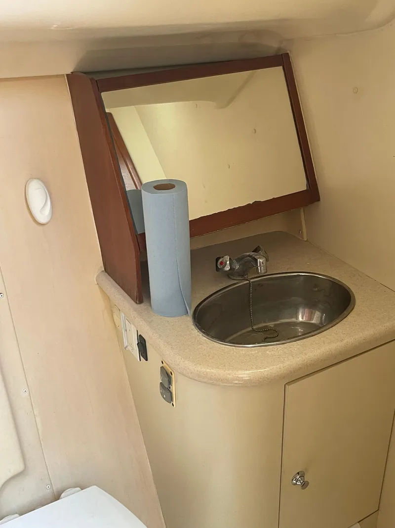 Slide: The Image of Interior of 2004 Hunter 44 DS Deck Salon with wooden finish and blue seating. - 25