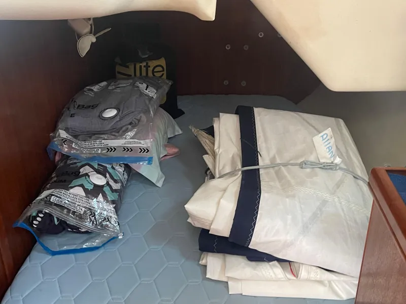 Slide: The Image of Luxurious interior of 2004 Hunter 44 DS Deck Salon with white seating and wooden table. - 26