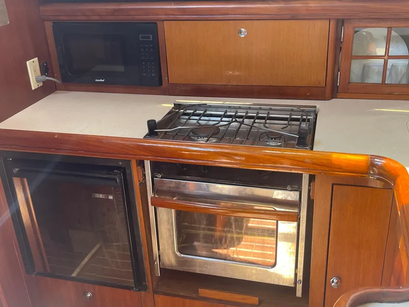Slide: The Image of Luxurious interior of 2004 Hunter 44 DS Deck Salon with wooden table and white seating. - 28