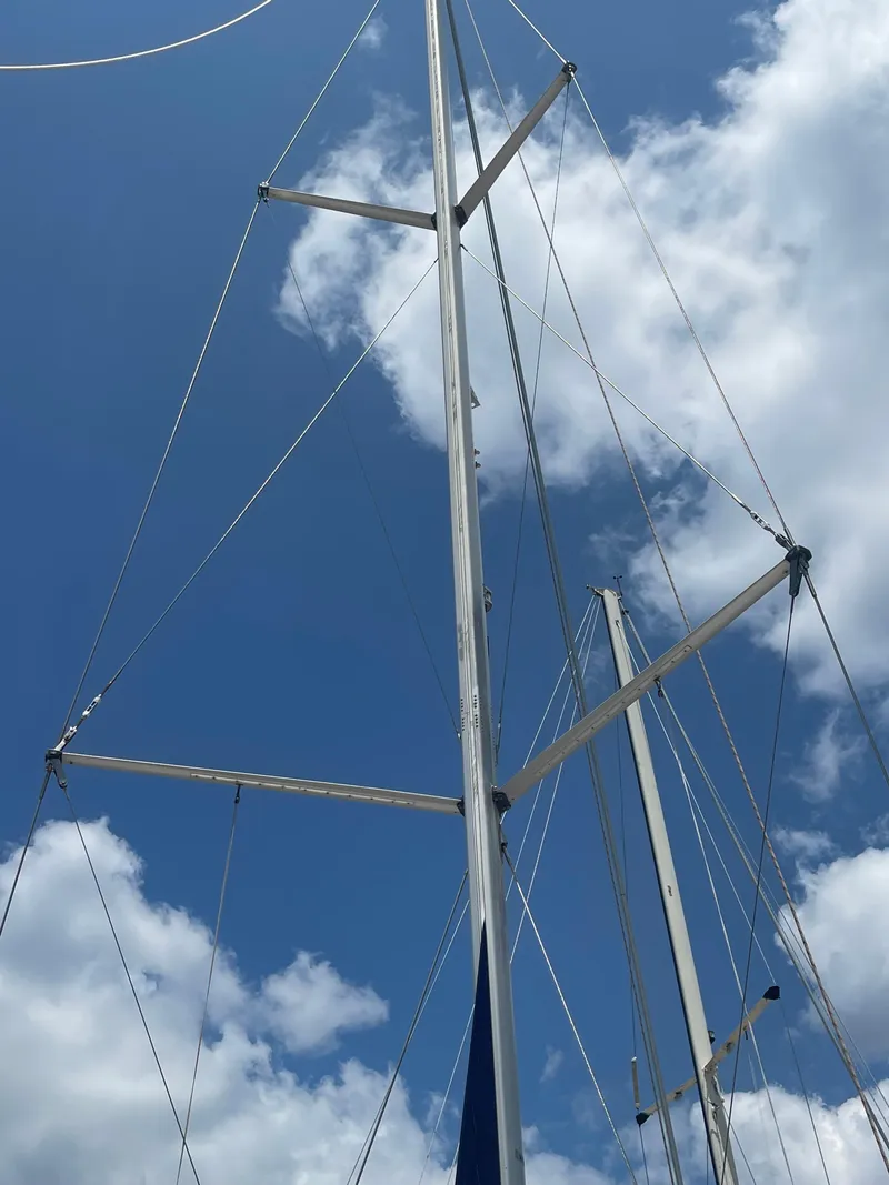 Slide: The Image of 2004 Hunter 44 DS Deck Salon sailboat with solar panels and Raymarine equipment in marina. - 37