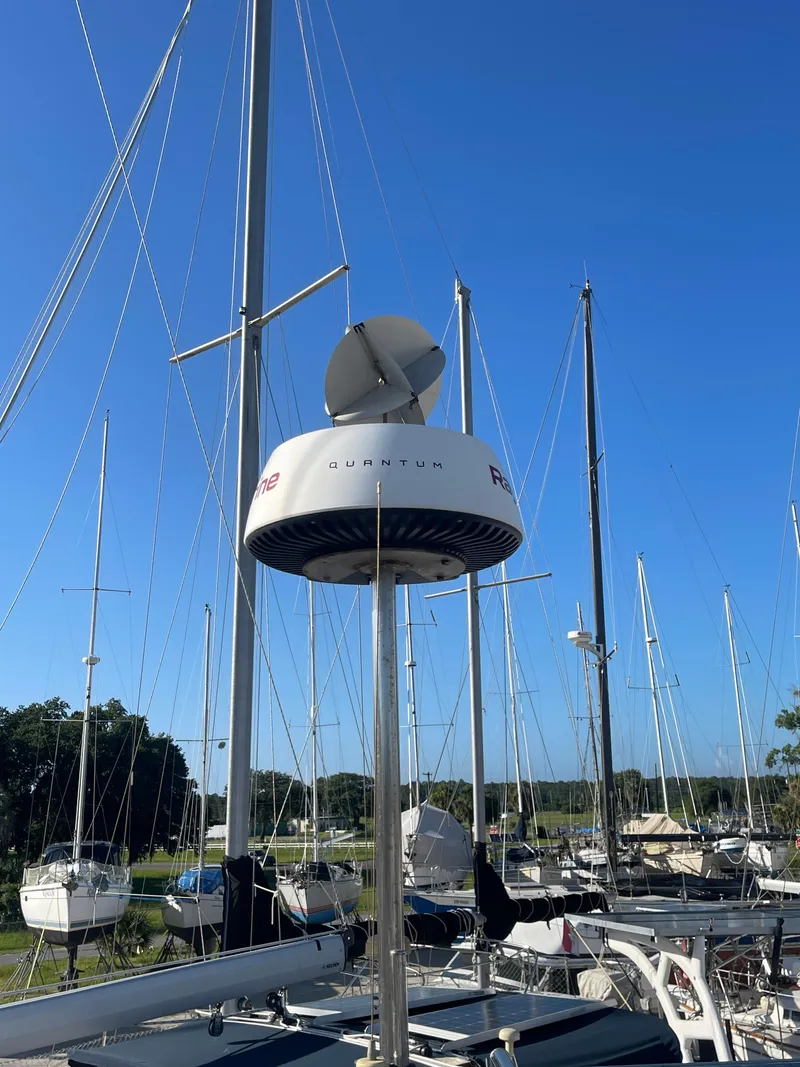 Slide: The Image of Mast of 2004 Hunter 44 DS Deck Salon sailboat against blue sky with clouds. - 41