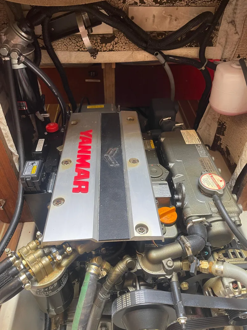 Slide: The Image of Hunter 44 DS Deck Salon 2004 sailboat with radar, surrounded by masts under clear blue sky. - 45