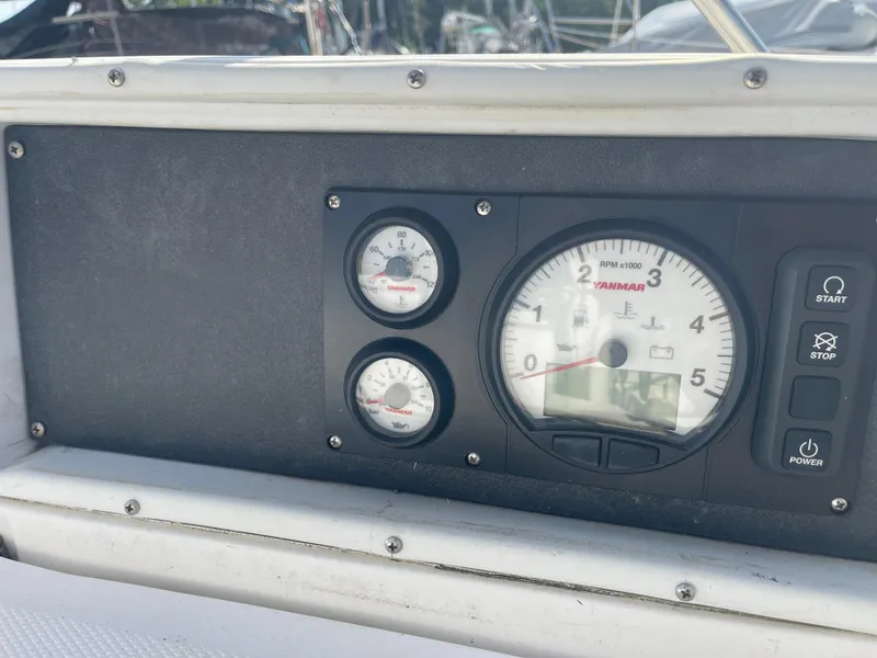 Slide: The Image of 2004 Hunter 44 DS Deck Salon sailboat in a marina, surrounded by other boats. - 47