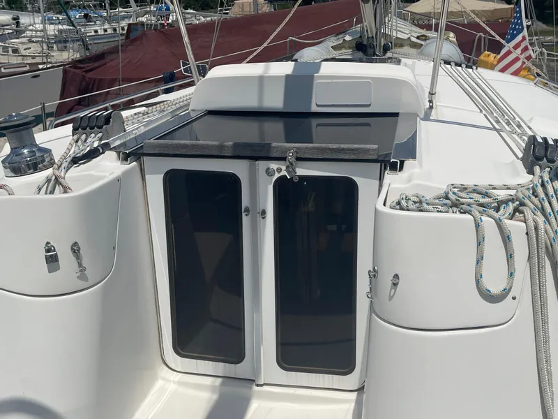 Slide: The Image of Hunter 44 DS Deck Salon 2004 sailboat hull supported by stands in a boatyard. - 5