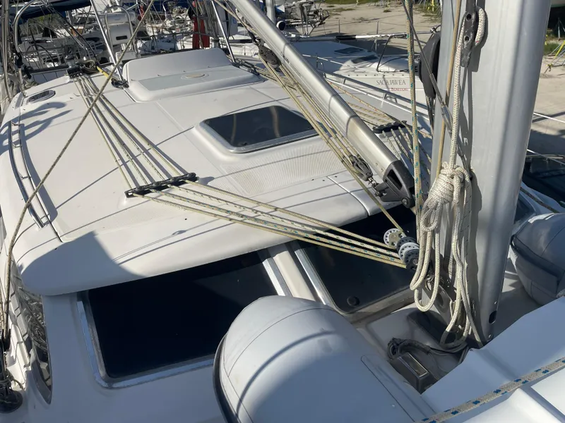 Slide: The Image of 2004 Hunter 44 DS Deck Salon yacht cockpit with ropes and closed hatch. - 9