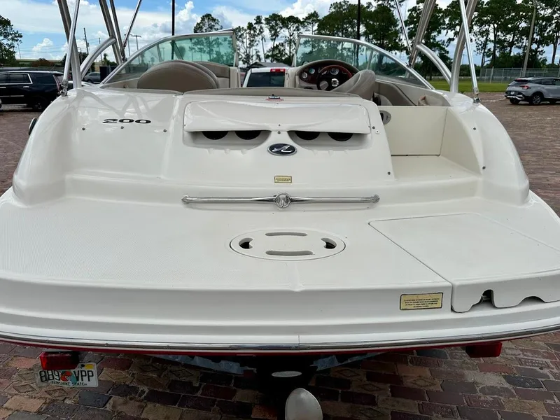 Slide: The Image of 2004 Sea Ray SunDeck 200 boat, rear view, parked on brick pavement. - 14