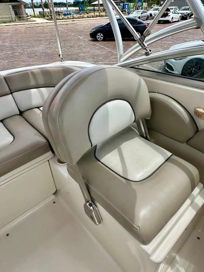Slide: The Image of 2004 Sea Ray SunDeck 200 boat interior with beige seating and stainless steel frame. - 19