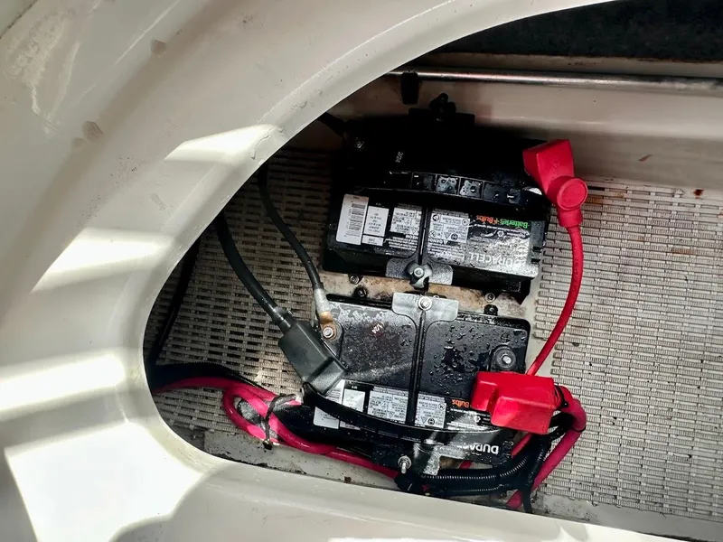 Slide: The Image of Battery compartment of a 2004 Sea Ray SunDeck 200 boat with visible wiring. - 22