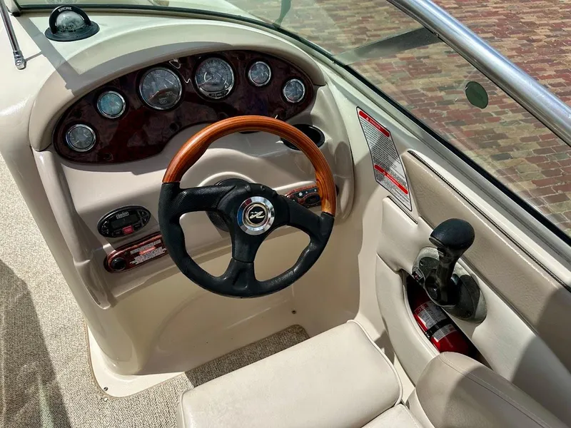 Slide: The Image of 2004 Sea Ray SunDeck 200 dashboard with wood-accented steering wheel and instrument panel. - 29