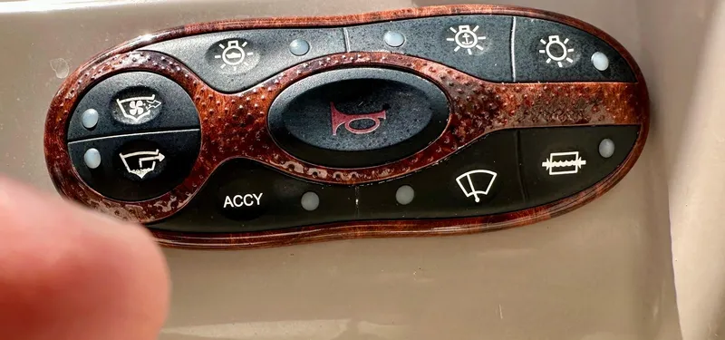 Slide: The Image of Control panel of a 2004 Sea Ray SunDeck 200 boat with various function buttons. - 30