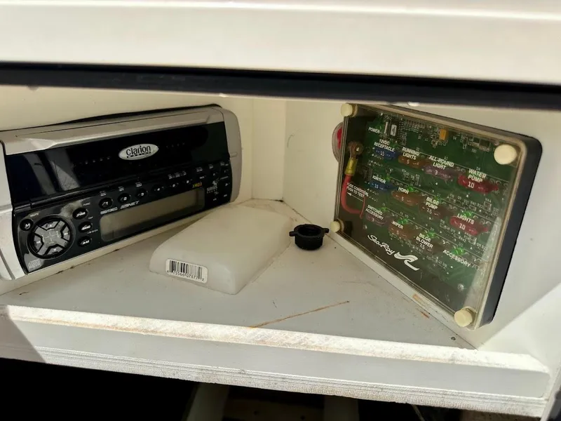 Slide: The Image of 2004 Sea Ray SunDeck 200 dashboard with Clarion stereo and fuse panel. - 33