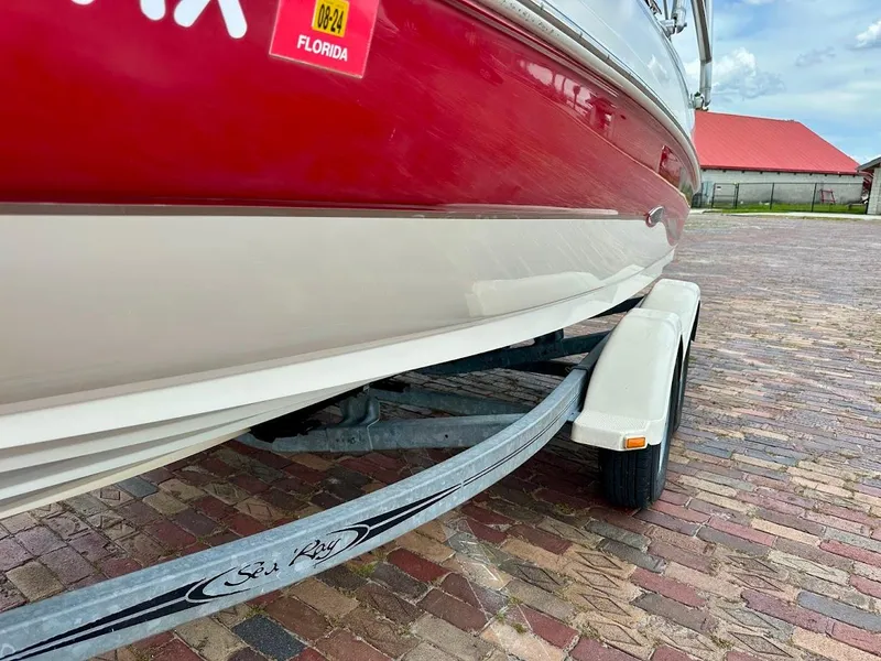 Slide: The Image of 2004 Sea Ray SunDeck 200 boat on trailer, red and white hull, Florida registration. - 5