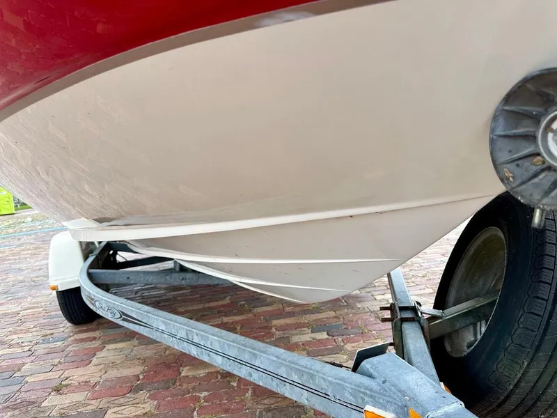 Slide: The Image of 2004 Sea Ray SunDeck 200 boat on trailer, showing hull and wheel detail. - 8