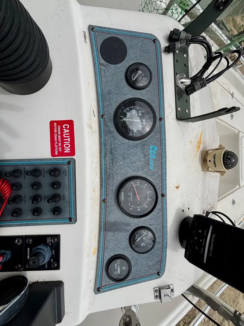 Slide: The Image of Control panel of a 2004 Sea Chaser 220 Bay Runner boat with gauges and switches. - 11