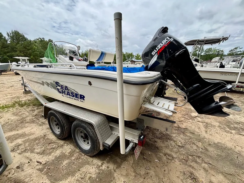 Slide: The Image of 2004 Sea Chaser 220 Bay Runner boat on trailer with Suzuki outboard motor. - 4