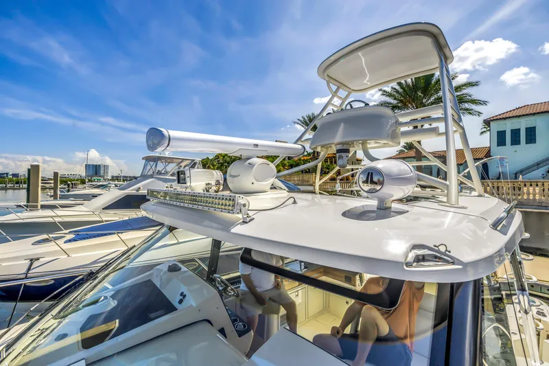Slide: The Image of 2023 Boston Whaler 405 Conquest yacht docked under a clear blue sky. - 10