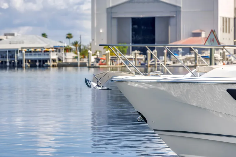 Slide: The Image of 2023 Boston Whaler 405 Conquest boat docked in a marina, calm water, and buildings in background. - 15