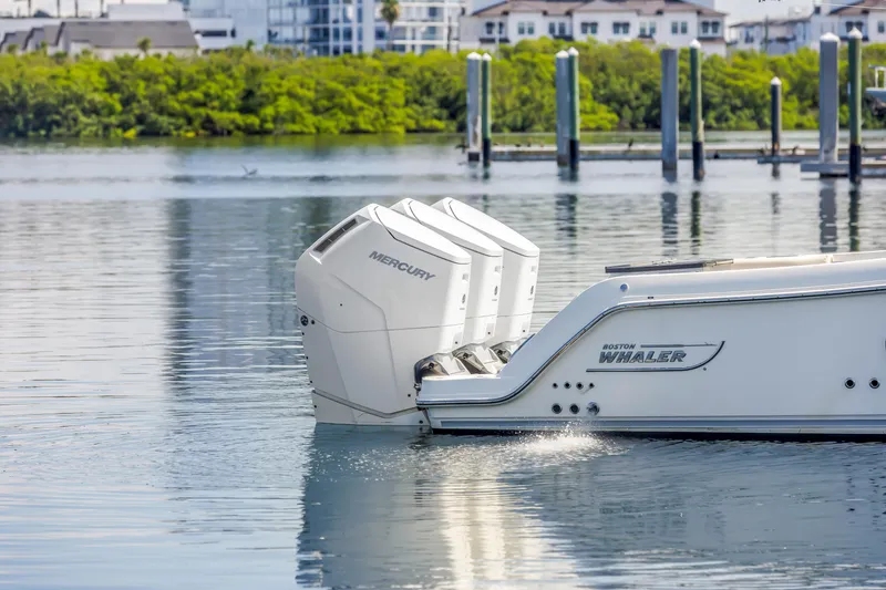 Slide: The Image of 2023 Boston Whaler 405 Conquest with Mercury engines on calm water. - 18