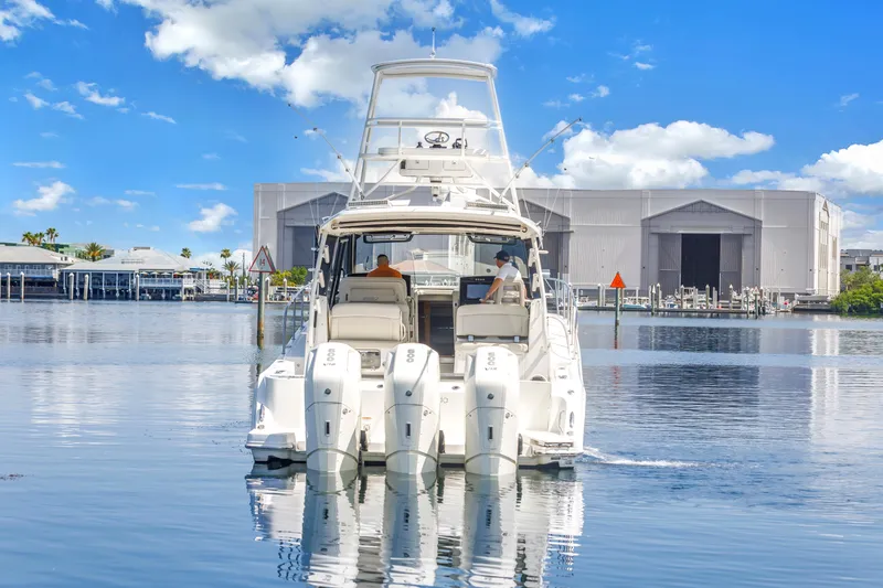 Slide: The Image of 2023 Boston Whaler 405 Conquest boat on calm water, clear sky background. - 19