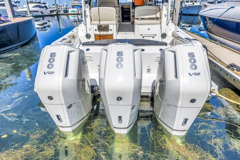 Slide: The Image of 2023 Boston Whaler 405 Conquest with triple Mercury 600 V12 engines docked at marina. - 20
