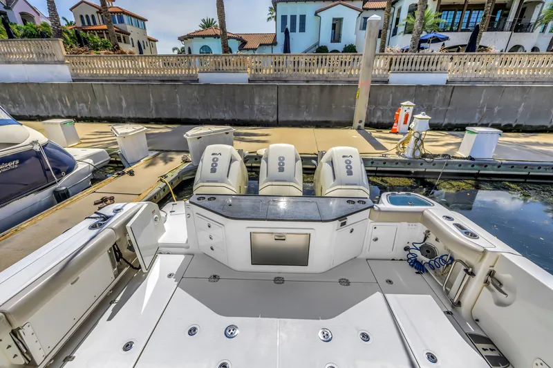 Slide: The Image of 2023 Boston Whaler 405 Conquest boat with triple engines docked at marina. - 21