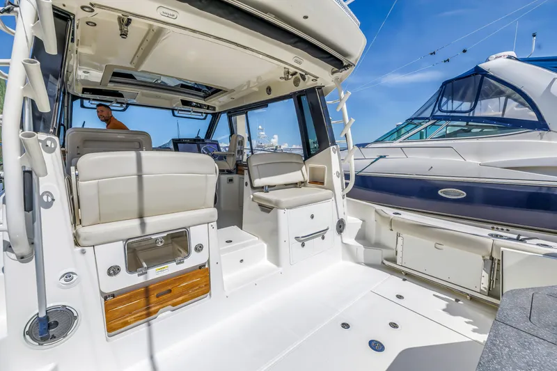 Slide: The Image of 2023 Boston Whaler 405 Conquest interior with seating, helm, and modern design. - 22