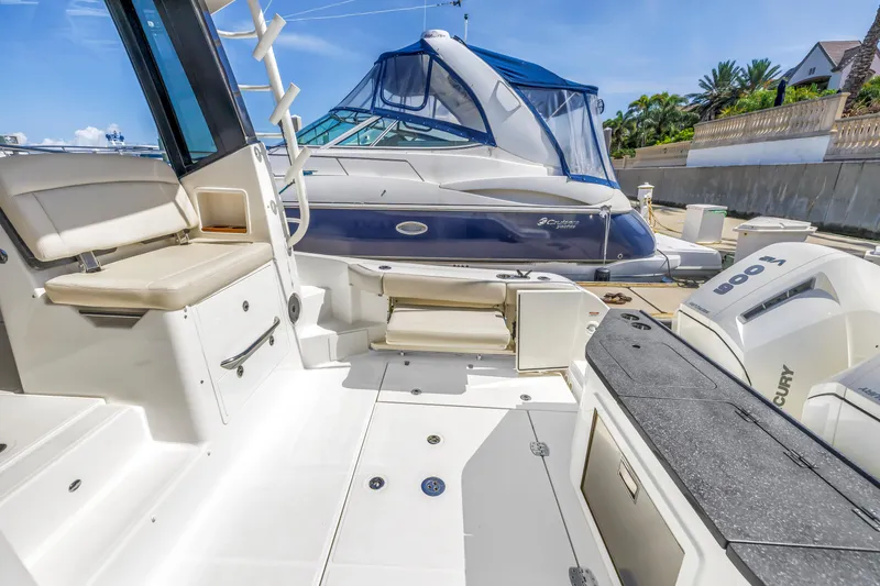 Slide: The Image of 2023 Boston Whaler 405 Conquest boat interior with seating and Mercury engines. - 23