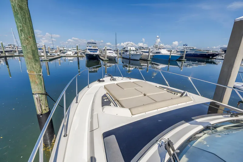 Slide: The Image of 2023 Boston Whaler 405 Conquest docked in a marina under clear blue skies. - 26